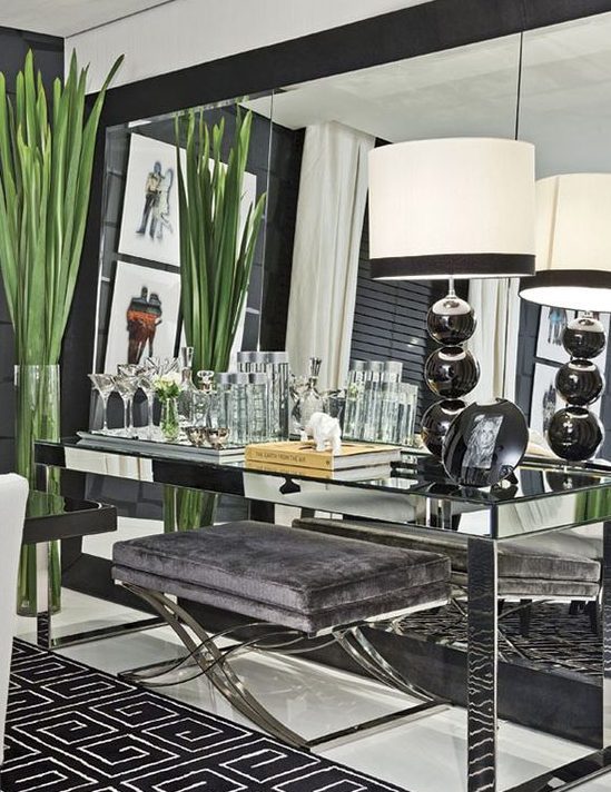 Mirrored Console Table with Lamp and Large Mirrors Leaning against wall behind