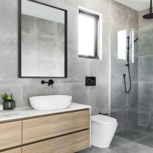 Black Frame REctangular Mirror on Grey Tiled Bathroom Wall