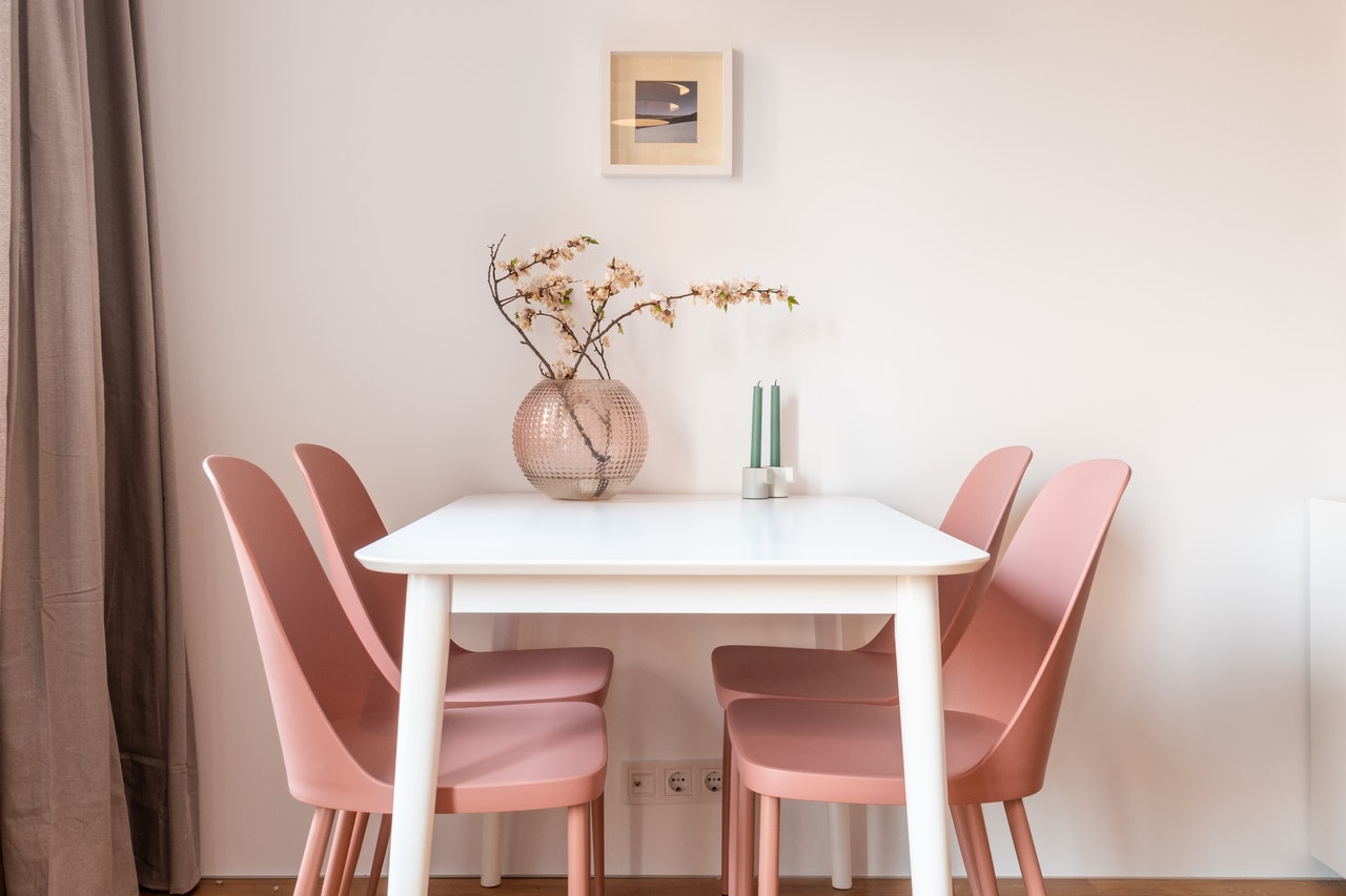 White Dining Table with Pastel Pink Chairs