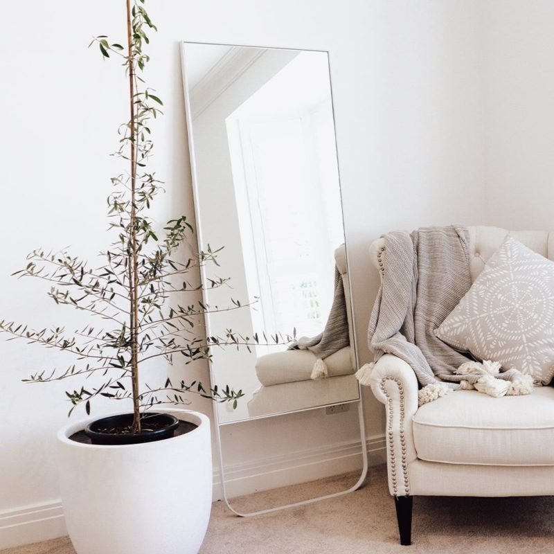 High Quality Oversized Mirror Leaning against a wall in a bedroom
